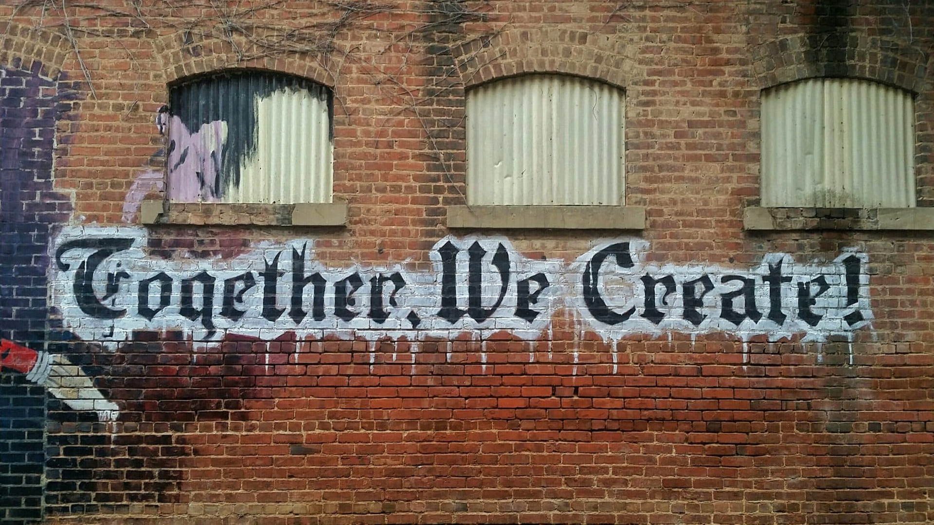 brand graphics on brick wall